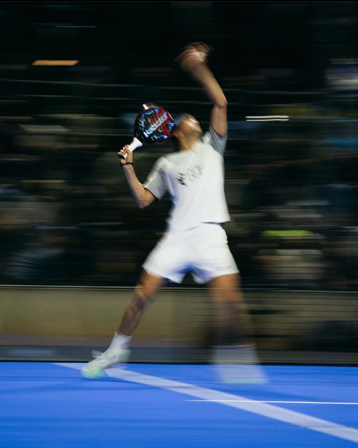 Padel player mid-swing in action