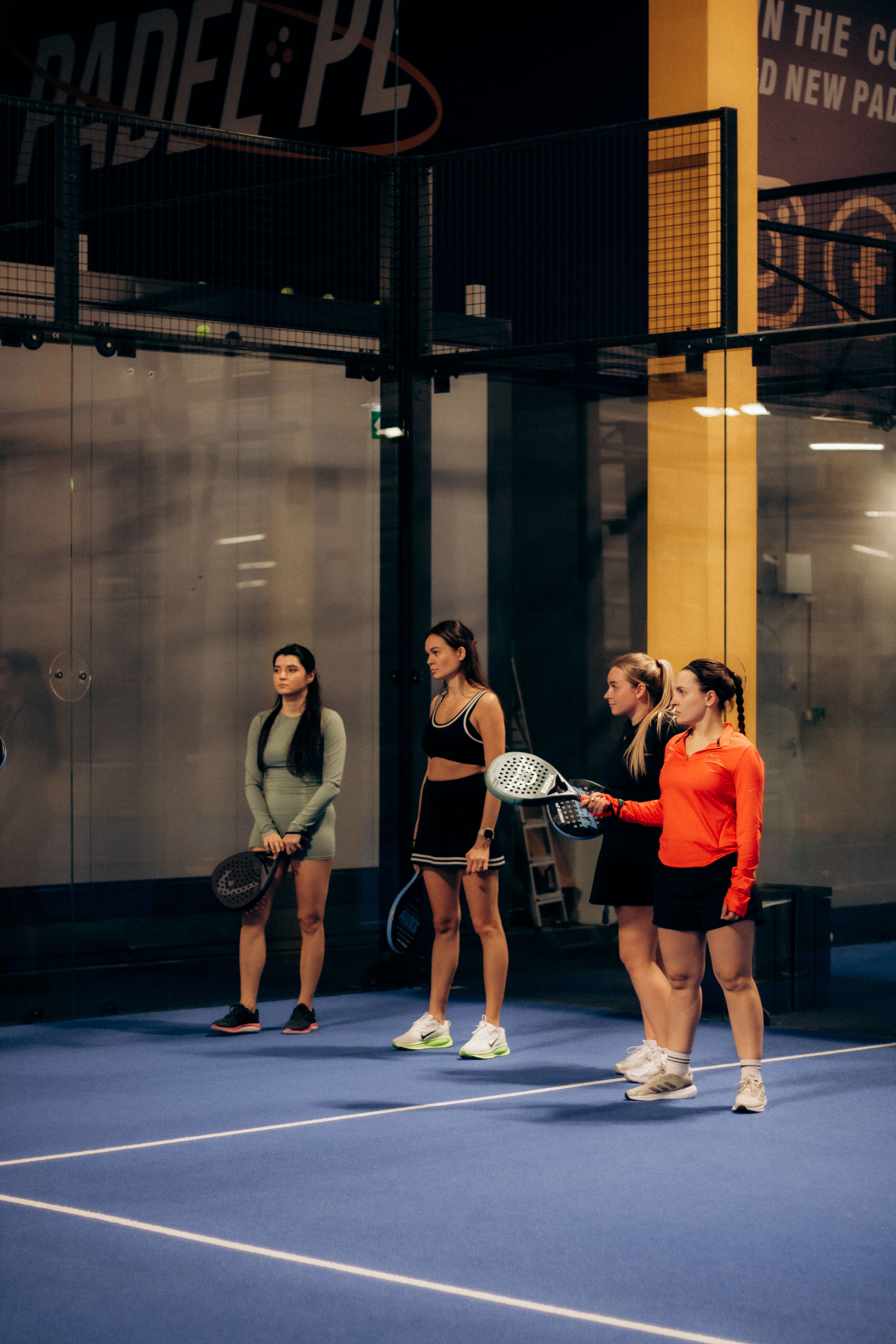 Group of players on an indoor padel court