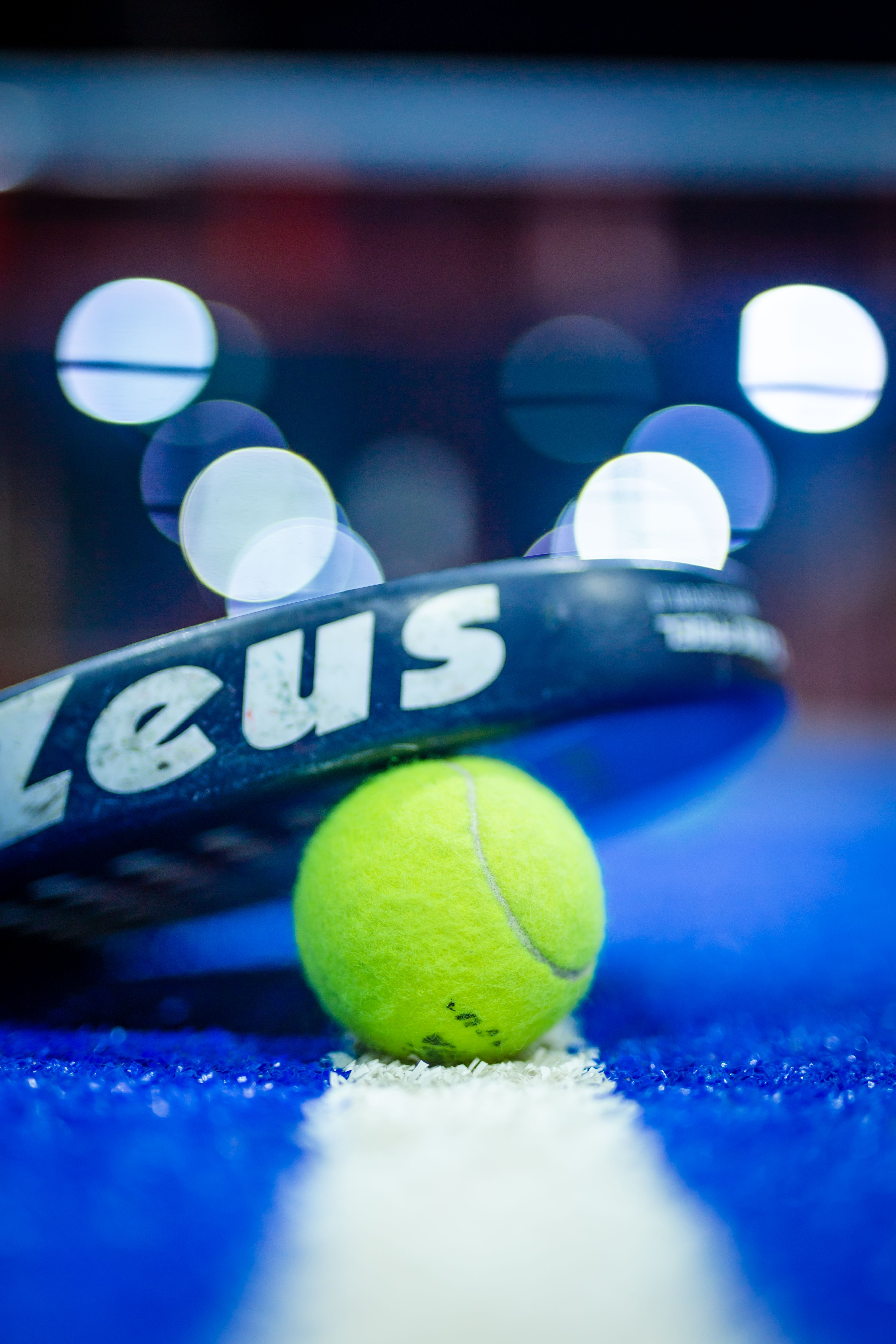 Padel racket and ball on court